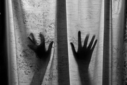 hands outlines on grungy window father raped